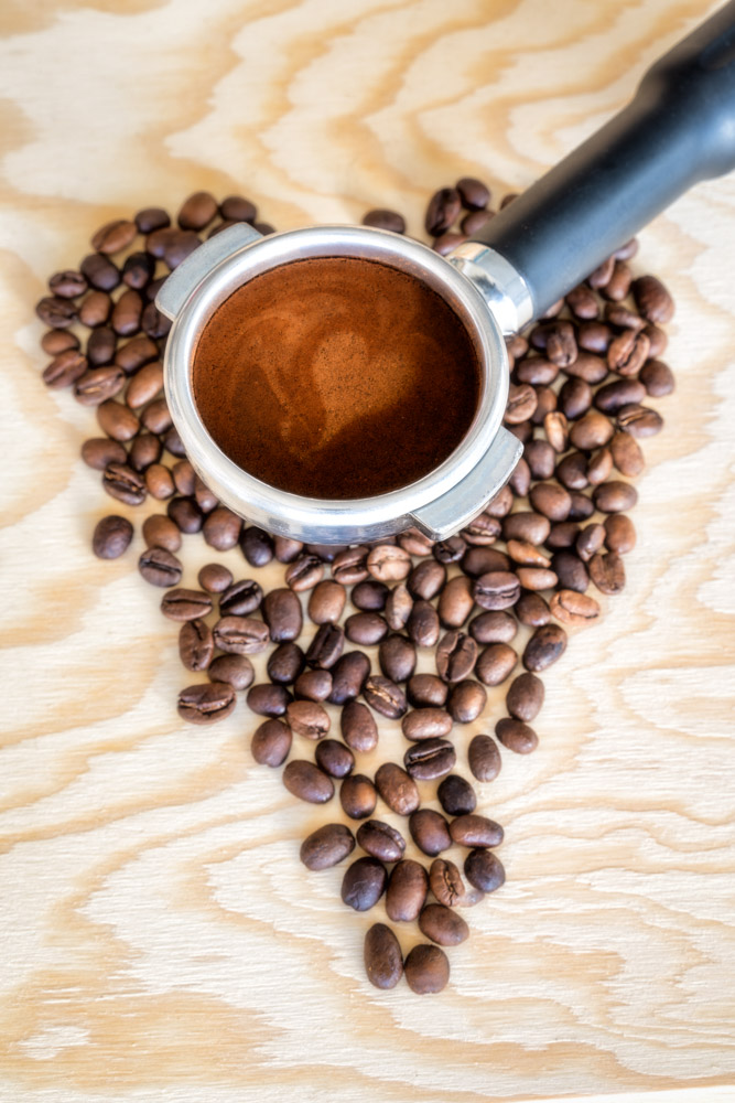 Espresso in coffee portafilter with heart shape